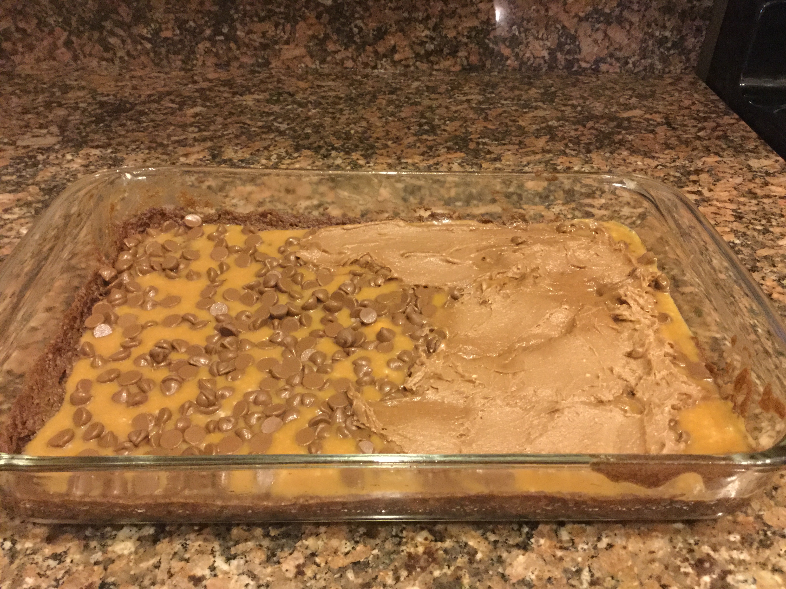 Spreading top layer of brownie mixture. 